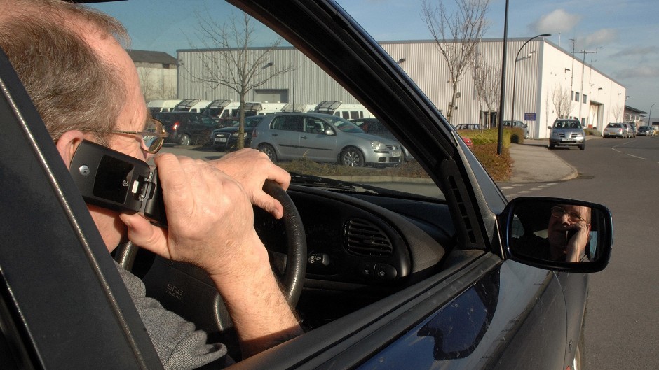 A motorist on his mobile phone while drving