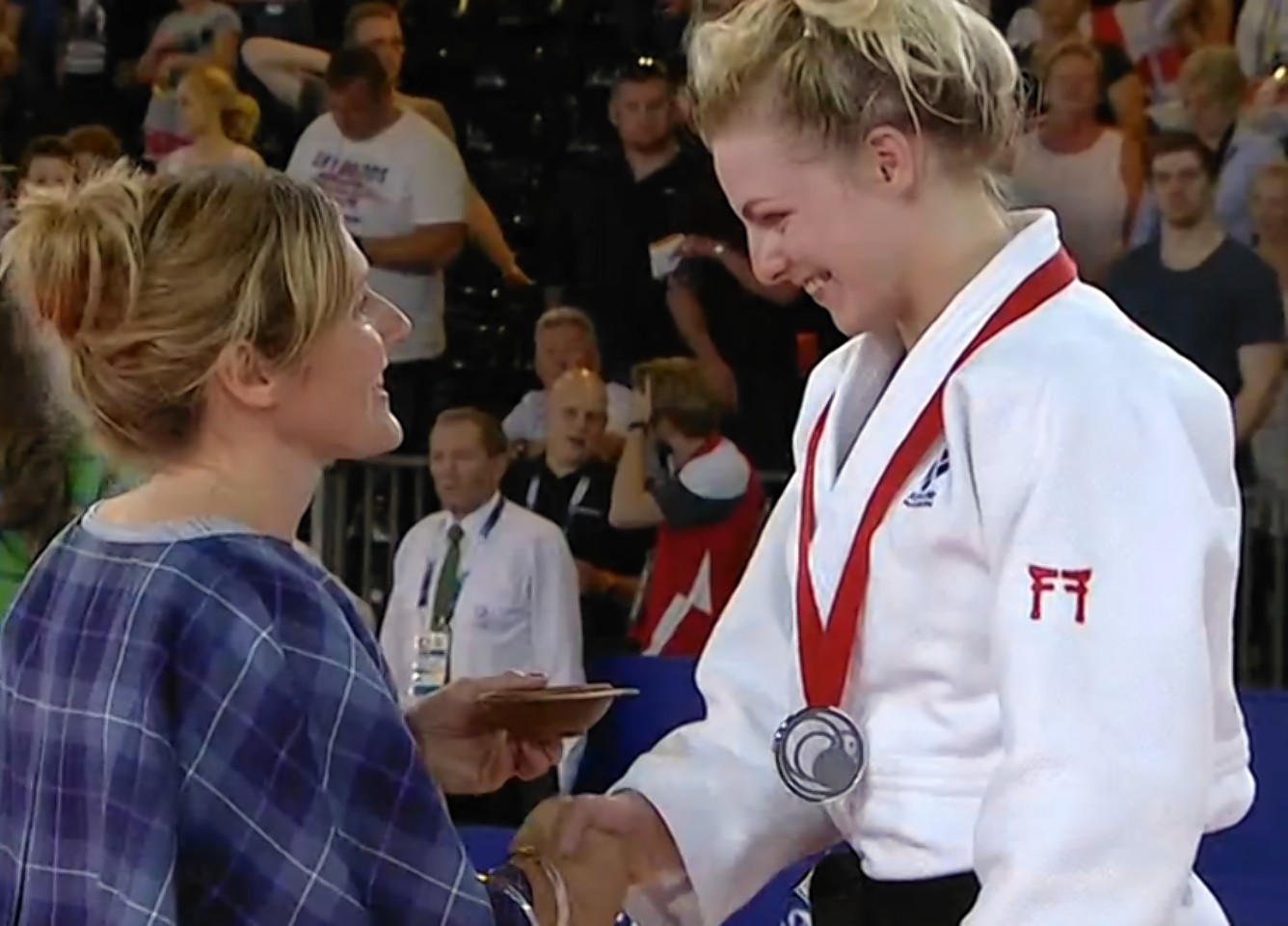 Inglis collecting her medal at the Glasgow games