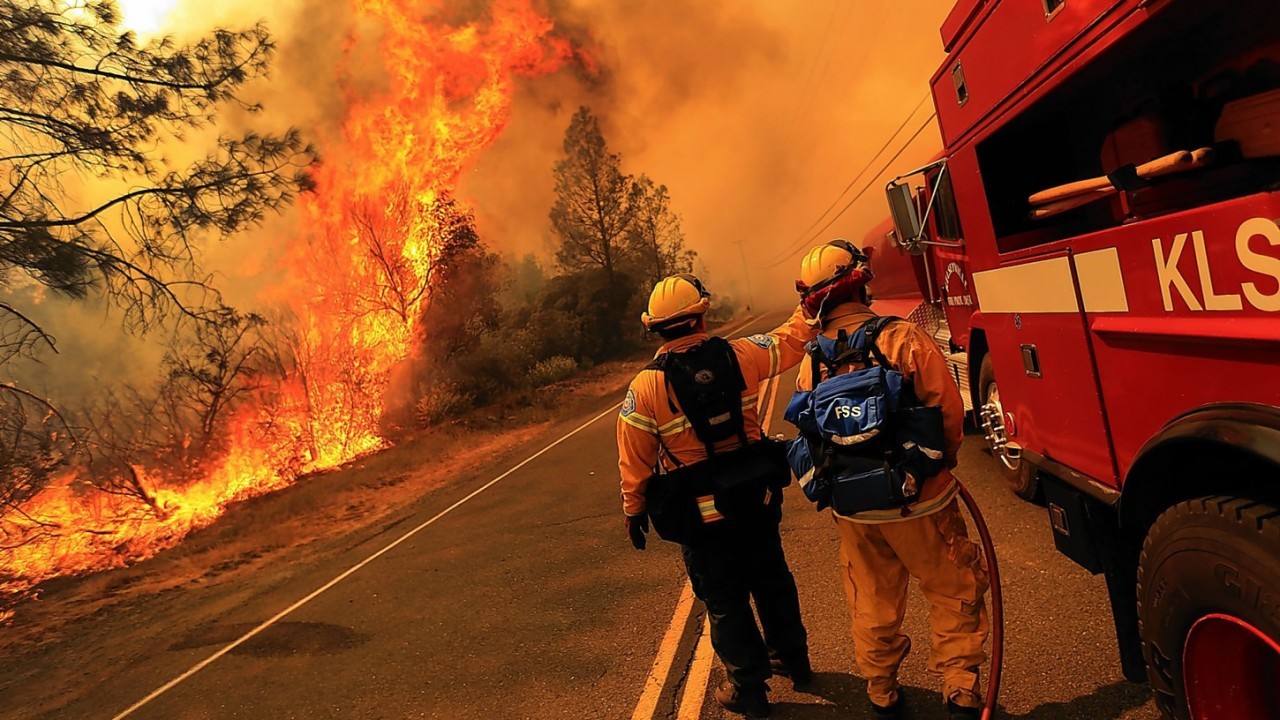 Kelseyville firefighters prepare to pull back from the fire on Butts Canyon Road, as the fire jumps the road, Tuesday July, 1, 2014, outside Middletown, Calif.