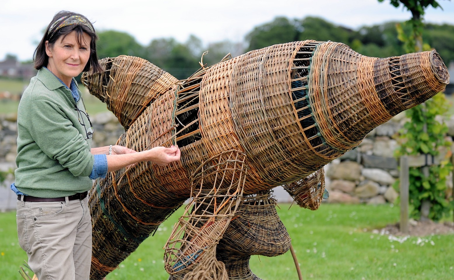 The wicker dolphin is repaired by Helen Jackson