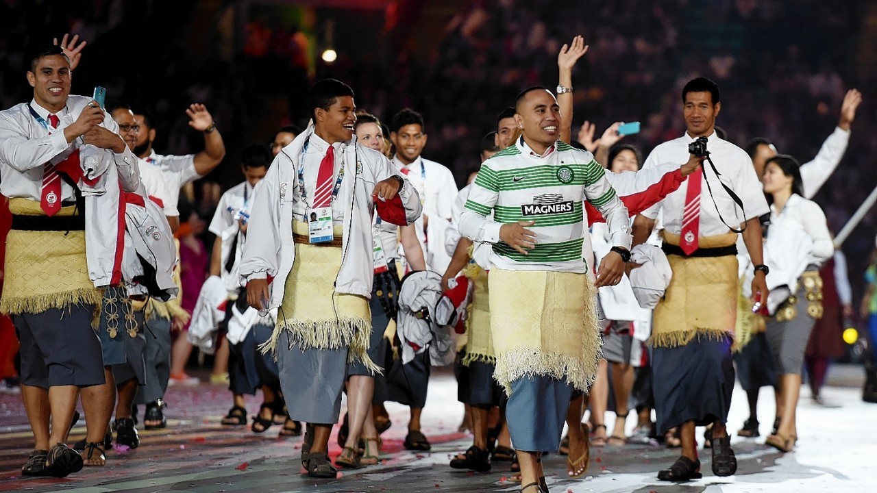 The athletes arrive at Celtic Park during last night's opening ceremony