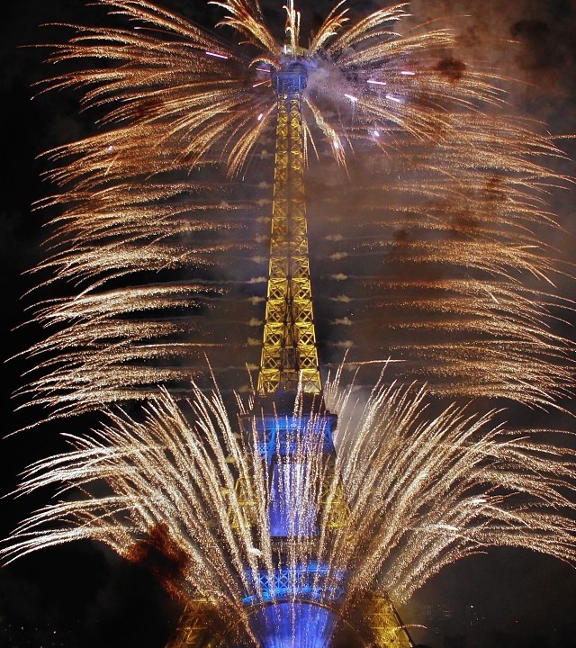 Fireworks illuminate the Eiffel Tower in Paris during Bastille Day celebrations, Monday, July 14, 2014.