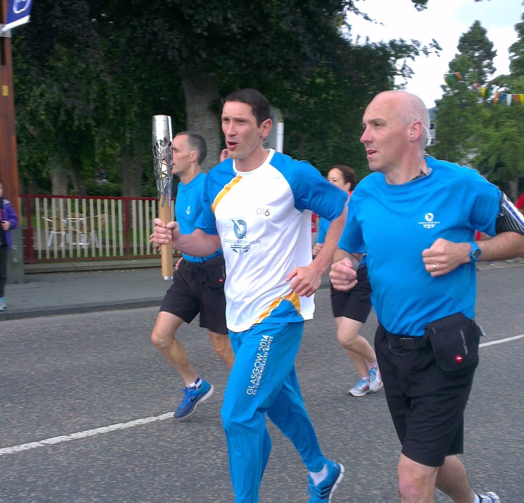 Shinty star Ronald Ross carries the baton through Aviemore