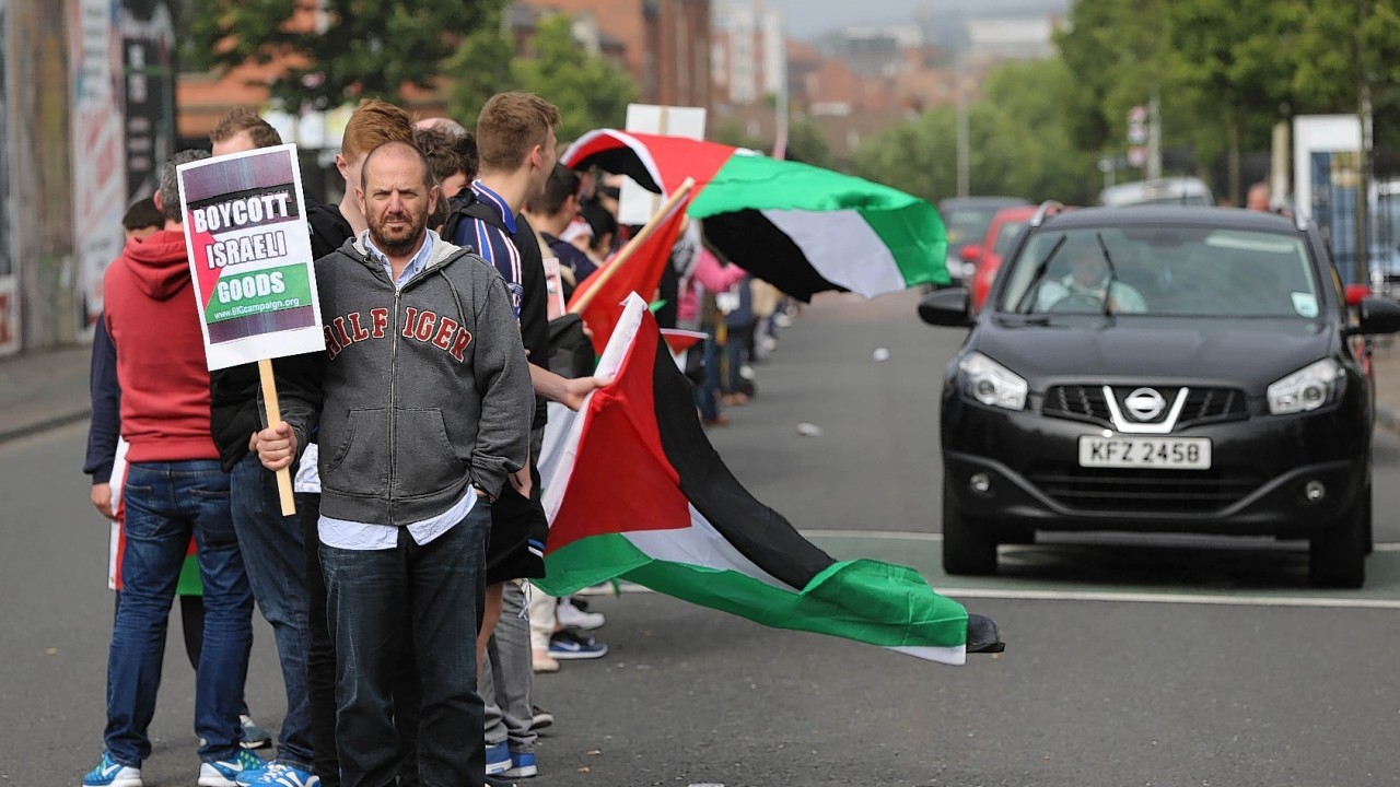 Crowds attend a white line picket on the Falls Road in Belfast organized by the Belfast Friends of Palestine in opposition to the Israeli Bombing of Gaza.