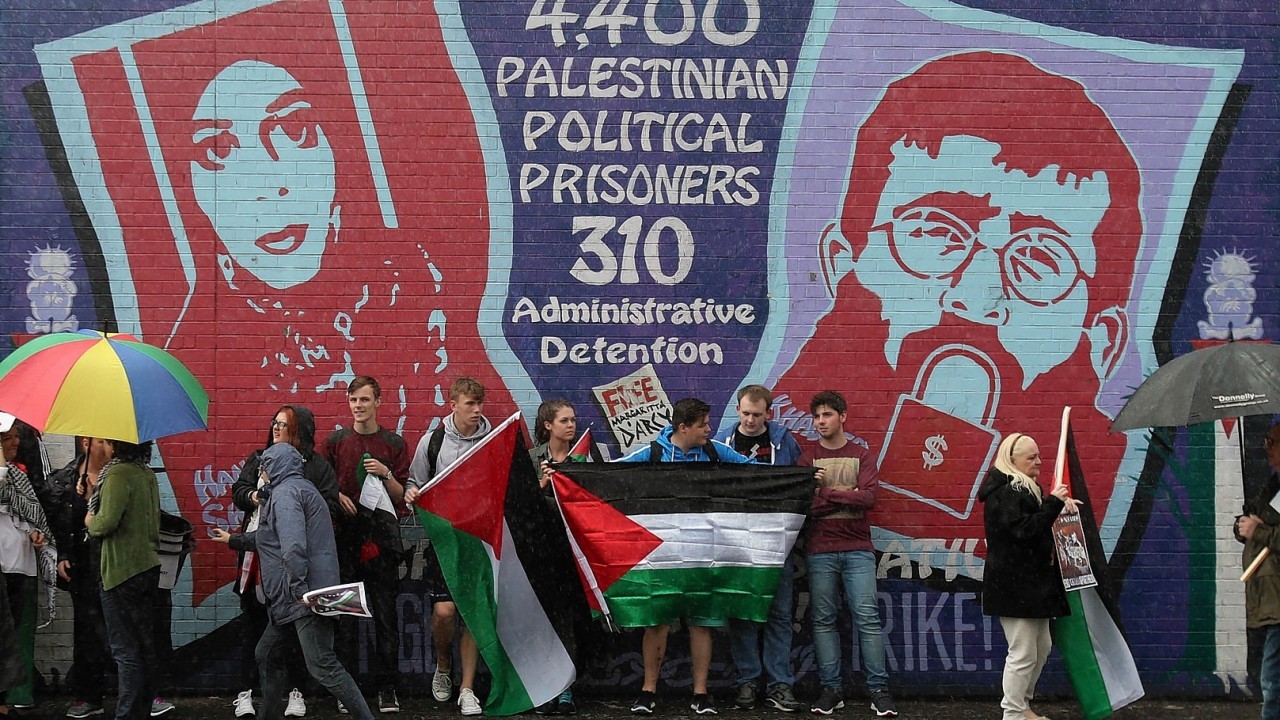 Crowds attend a white line picket on the Falls Road in Belfast organized by the Belfast Friends of Palestine in opposition to the Israeli Bombing of Gaza.