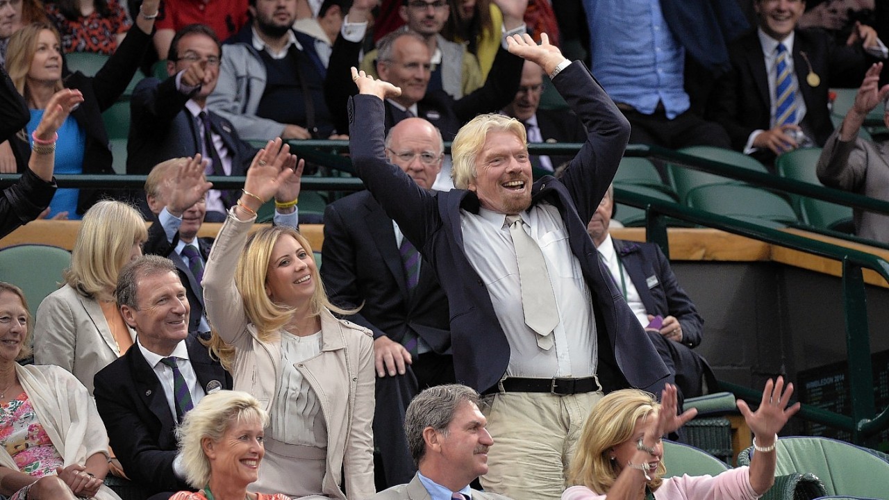 Holly and Richard Branson join in a mexican wave from the royal box during day eight of the Wimbledon Championships at the All England Lawn Tennis and Croquet Club, Wimbledon.