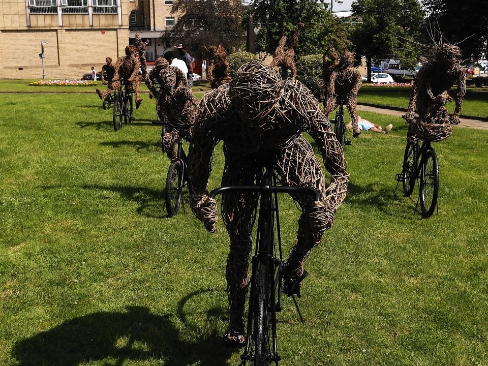 vA view of 'La Grande Famille' a life-sized family of cyclists made of willow on steel armatures by the artist Carole Beavis in Huddersfield.