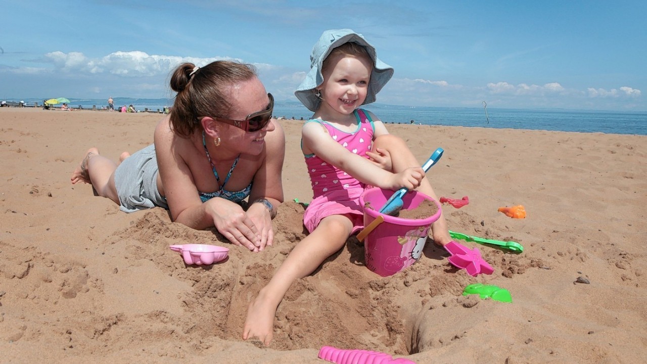 People enjoy a bright sunny day on Portobello beach near Edinburgh. July 22 2014