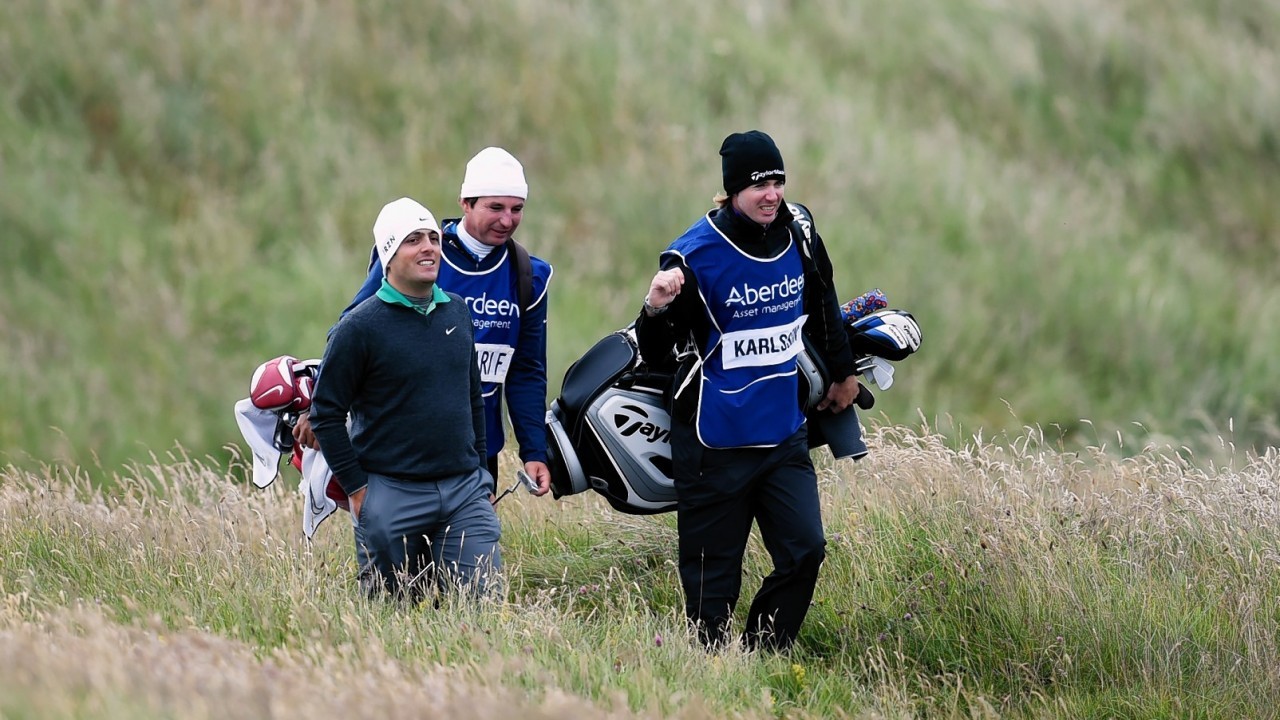 Italy's Francesco Molinari (left) is all smiles on his approach to the green