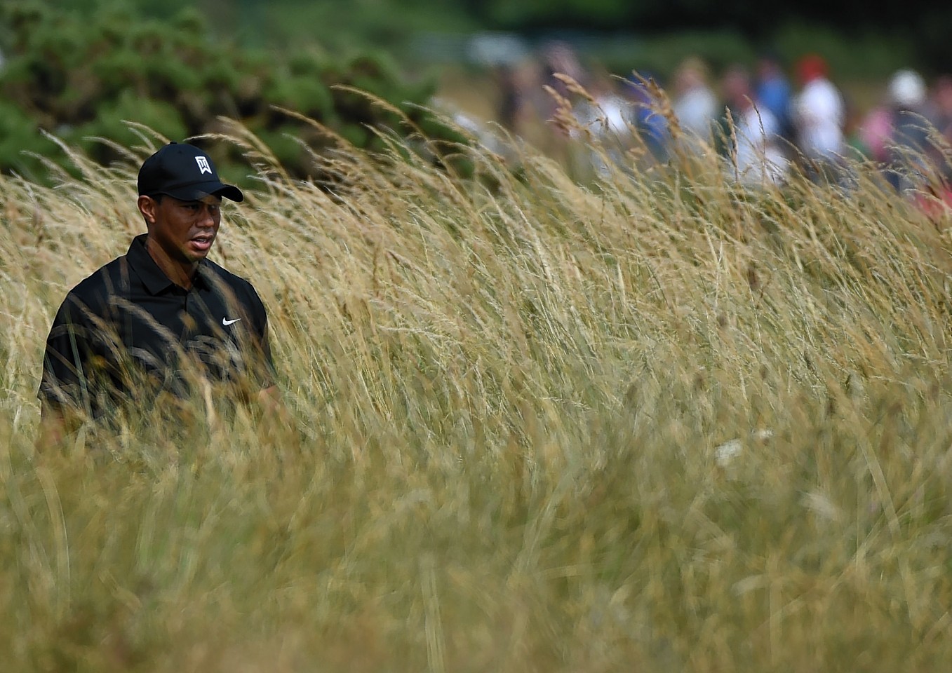 Phil Mickelson plays an iron shot from the rough