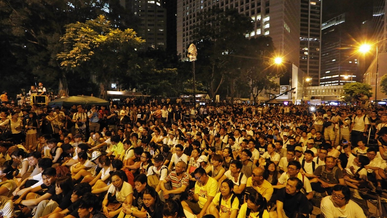 Hundreds of protesters stage a peaceful sit-ins overnight on a street in the financial district in Hong Kong Wednesday, July 2, 2014