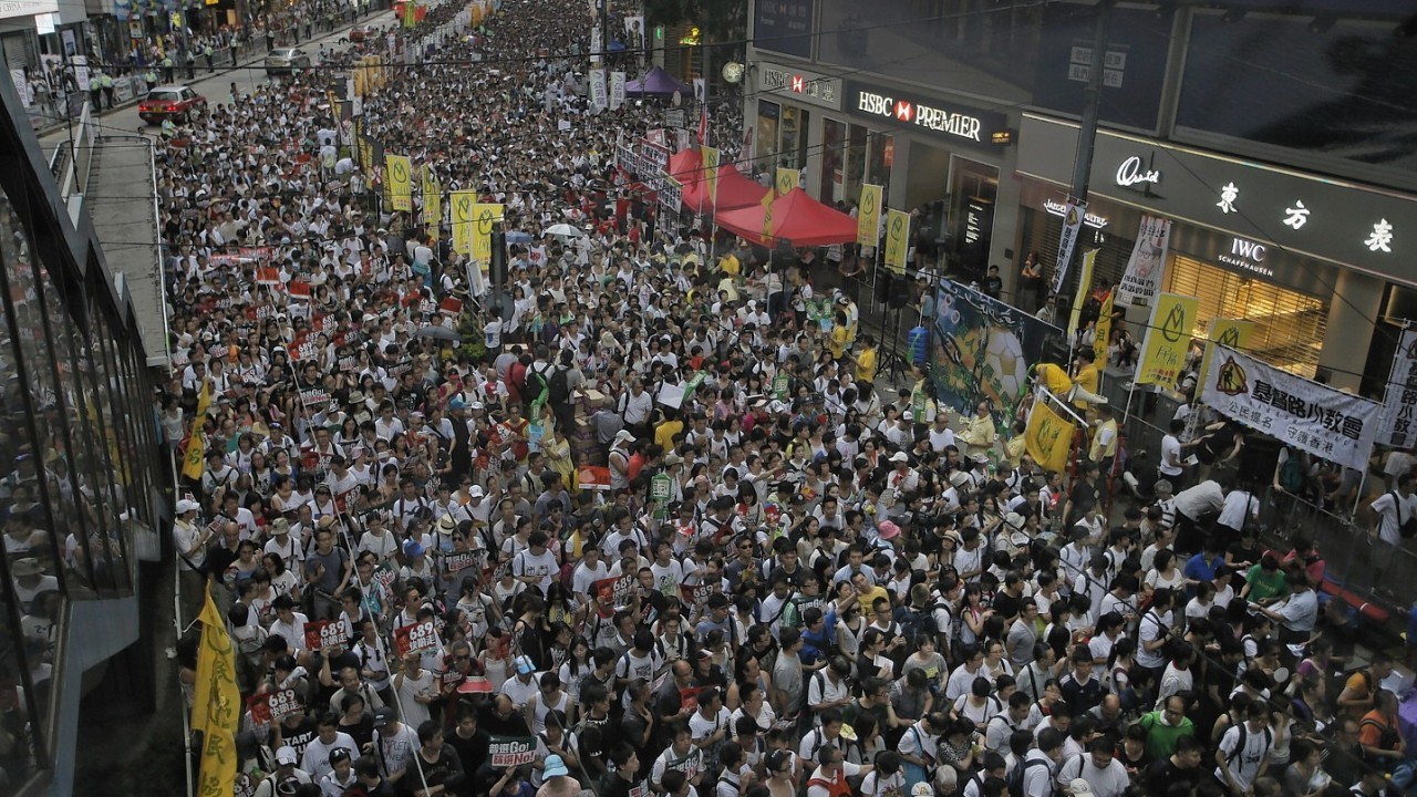 People march on a street during the annual pro-democracy protest on July 1, 2014 in Hong Kong