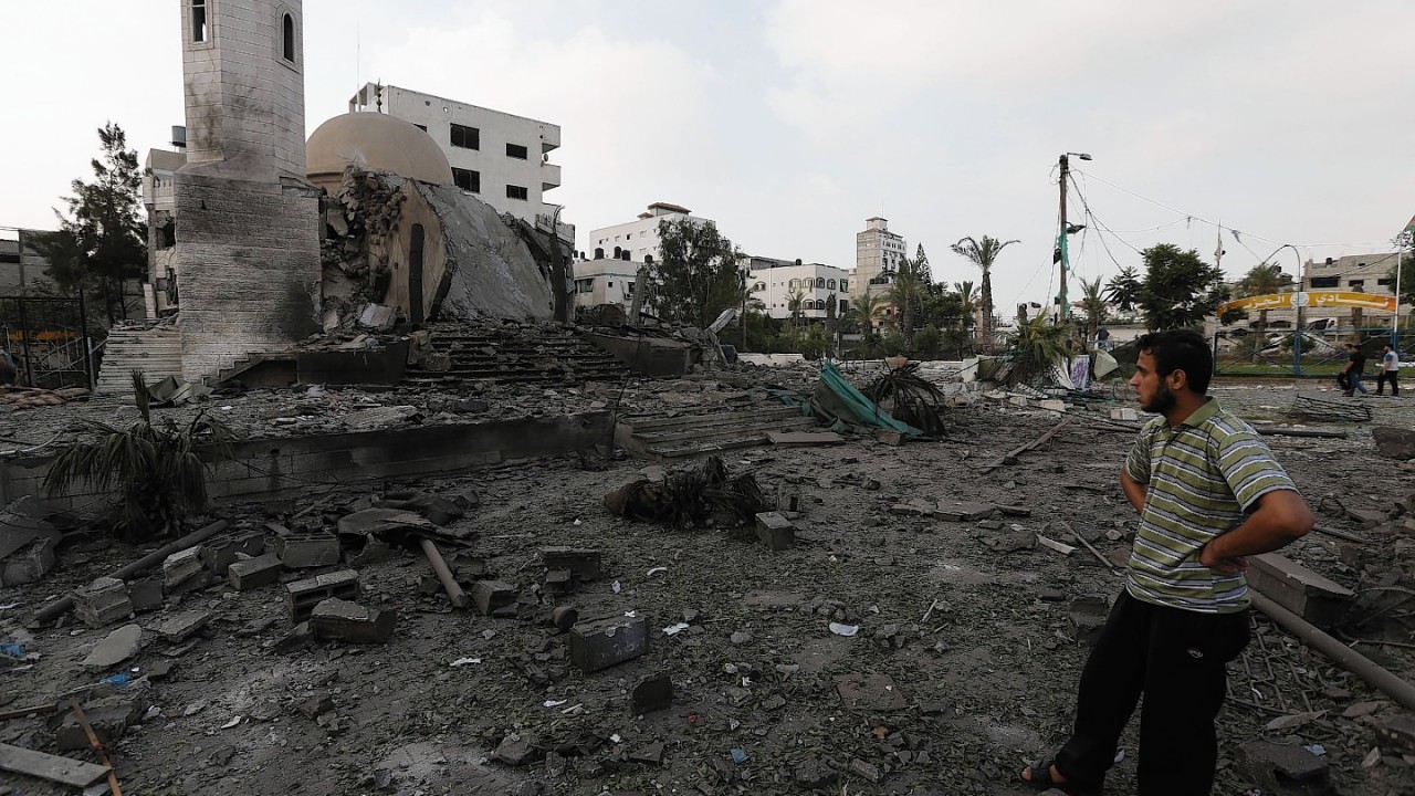 Palestinians inspect the damage of the Al-Shalam (Peace) tower, destroyed by an overnight Israeli strike, in Gaza City, Tuesday, July 22, 2014