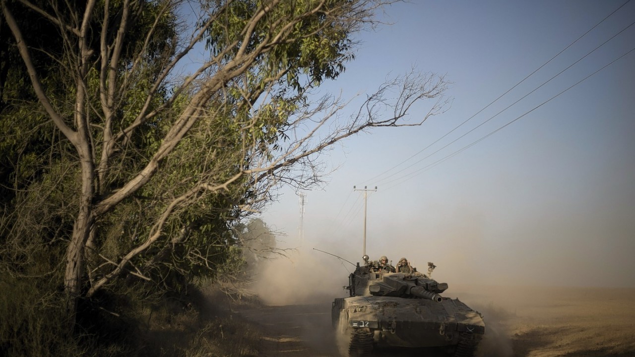 Israeli soldiers ride on a tank to a position near Israel Gaza Border, Thursday, July 10, 2014