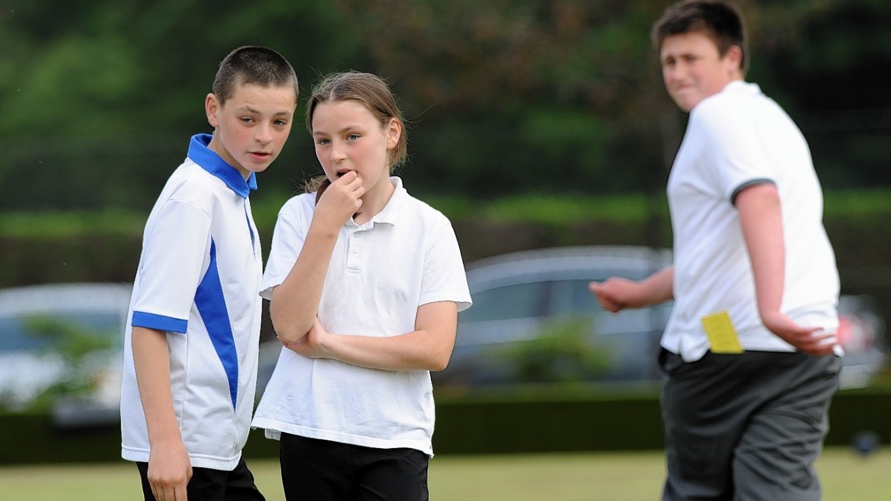 Brother and sister Liam and Lucy Willox from Insch discuss strategy with Liam Angus from Newhills looking back, in the Junior Pairs at City of Aberdeen bowling tournament, Westburn