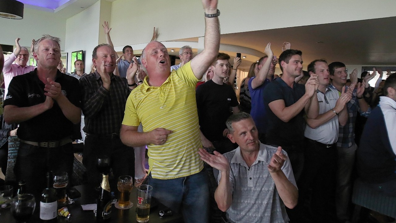 Fans watch Rory McIlroy win The Open on tv screens at Holywood Golf Course, County Down