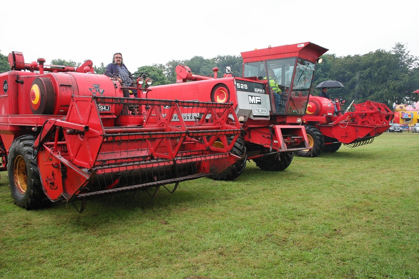 Three Massey Ferguson combines manufactured in Kilmarnock help swell the main ring during the machinery parade
