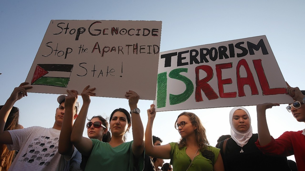 Demonstrators hold up placards during a protest against the war in Gaza, in Beirut, Lebanon, Monday July 21, 2014
