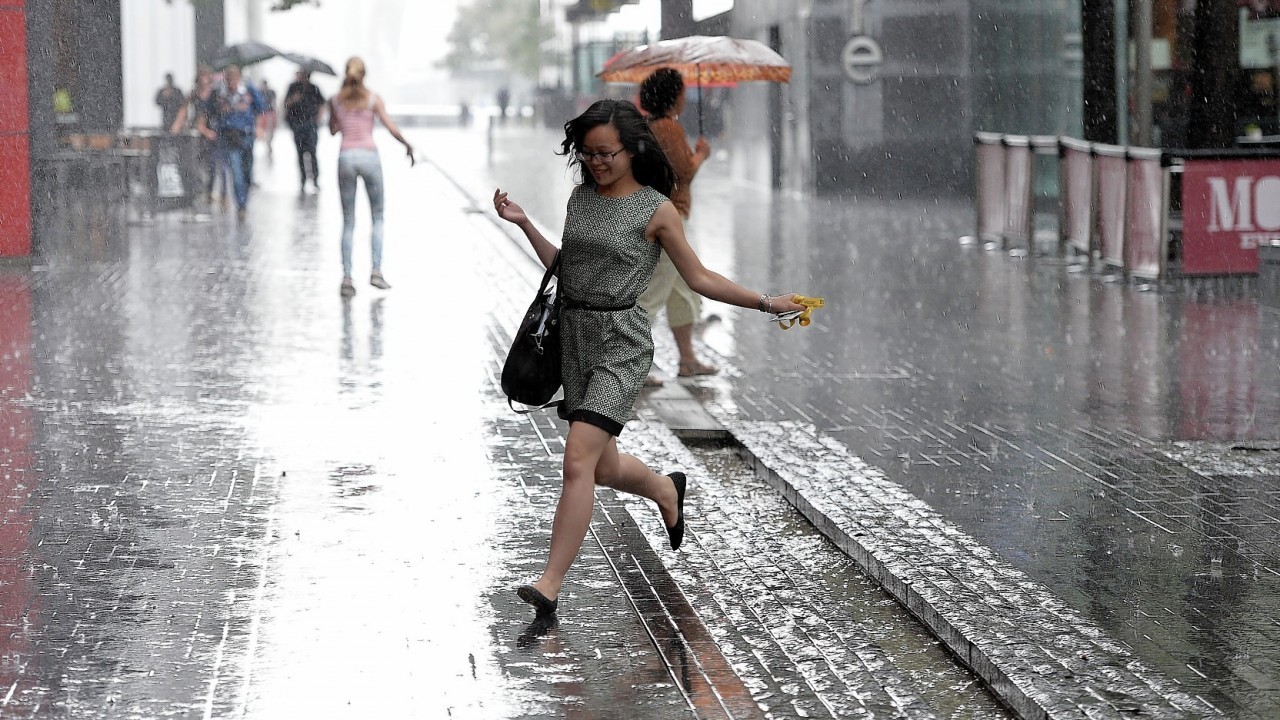Members of the public get soaked as heavy rain falls in the City of London, London