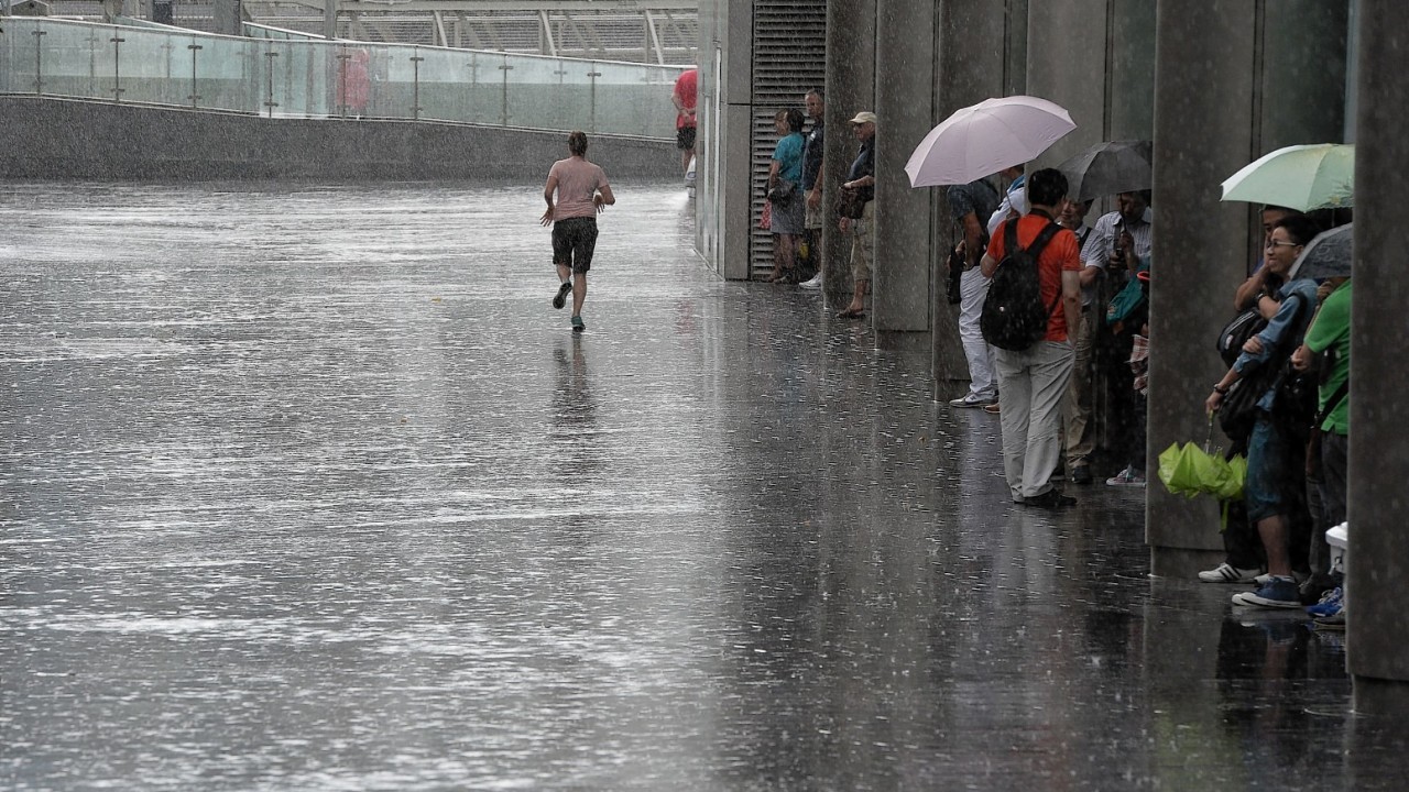 Members of the public get soaked as heavy rain falls in the City of London, London