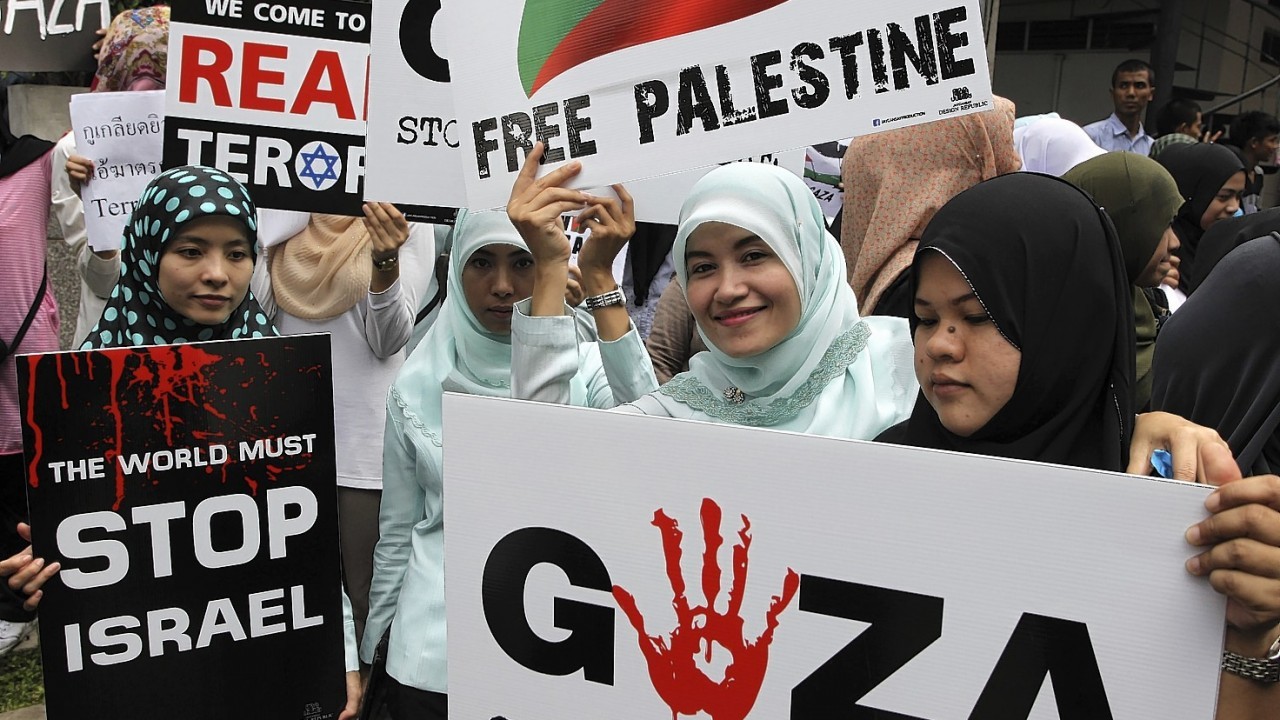Thai-Muslim activists hold up banners during a rally outside the Israeli embassy in Bangkok. Several hundreds of activists took part in the rally to show solidarity for Palestine against Israel's attacks on Gaza