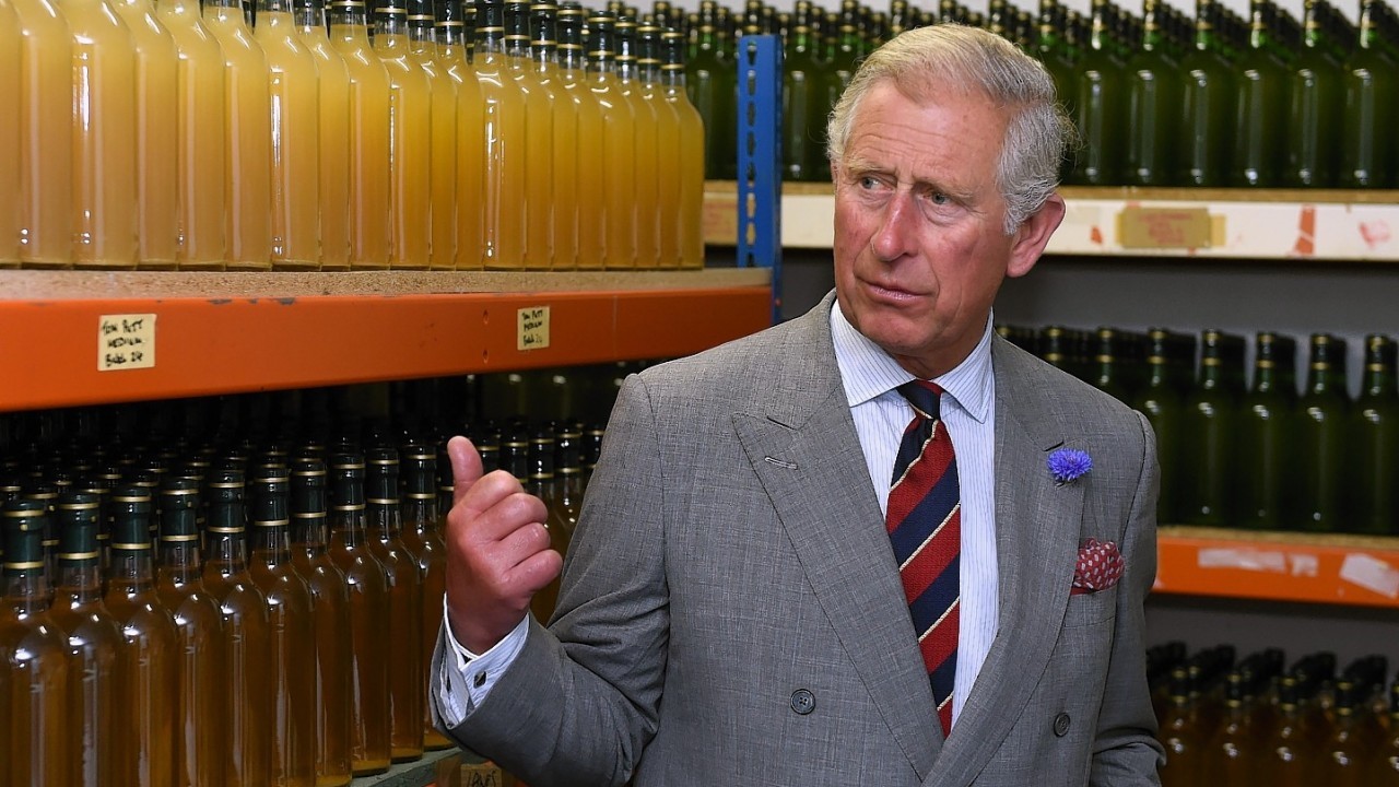 The Prince of Wales views bottles of organic apple juice during a visit to the family-run Welsh Farmhouse Apple Juice company in Crickhowell, Powys