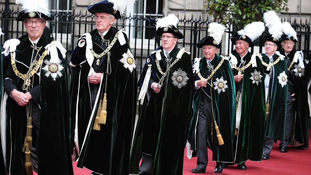 Knights of the Thistle including Lord Robertson (third from left) arrive at St Giles Cathedral in Edinburgh to  attend the Thistle Service