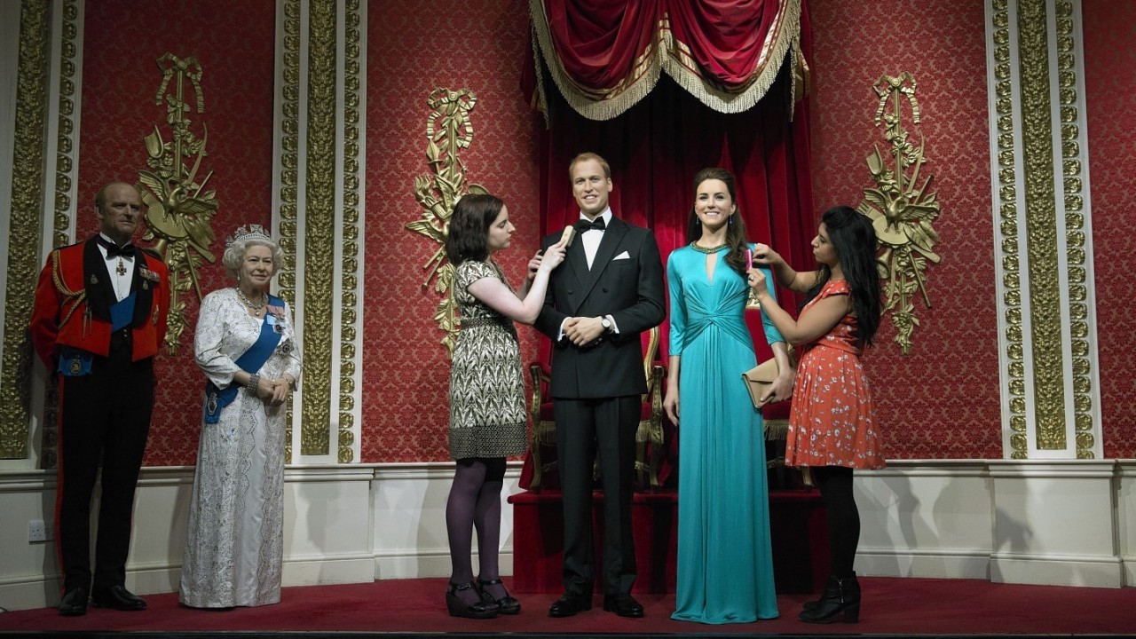 Wardrobe assistant Luisa Compobassi (left) and hair stylist Caryn Bloom apply finishing touches to the wax figures of the Duke and Duchess of Cambridge as they are unveiled at Madame Tussauds, London.