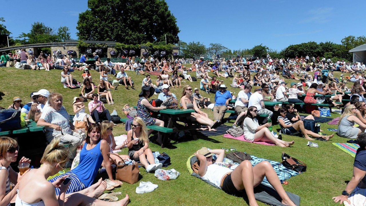 Fans enjoy the sun on Murray Mount during day eleven of the Wimbledon Championships at the All England Lawn Tennis and Croquet Club, Wimbledon.