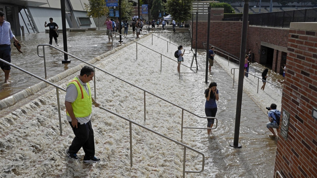 People walk down a stairway leading to a parking structure across from Pauley Pavilion on the UCLA campus after flooding from a broken 30-inch water main under nearby Sunset Boulevard inundated a large area of the campus in the Westwood section of Los Angeles