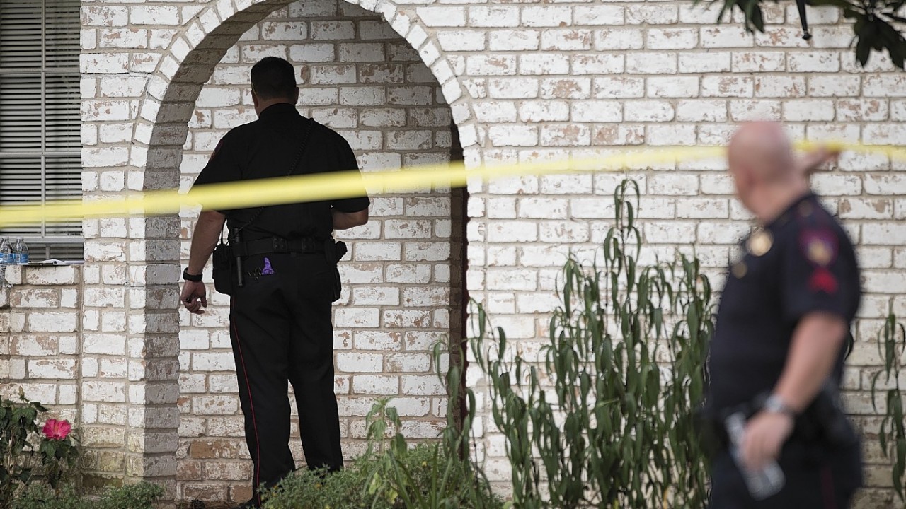 Law enforcement officers investigate the scene of a shooting Wednesday, July 9, 2014, in Spring, Texas