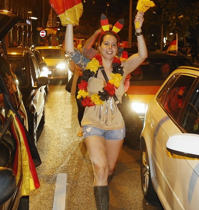 German soccer fans celebrate after the World Cup final between Germany and Argentina in downtown Frankfurt, Germany, early Monday, July 14, 2014