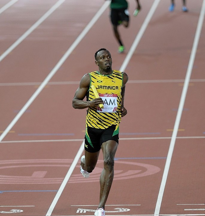 Usain Bolt crosses the line in the 4x100m relay