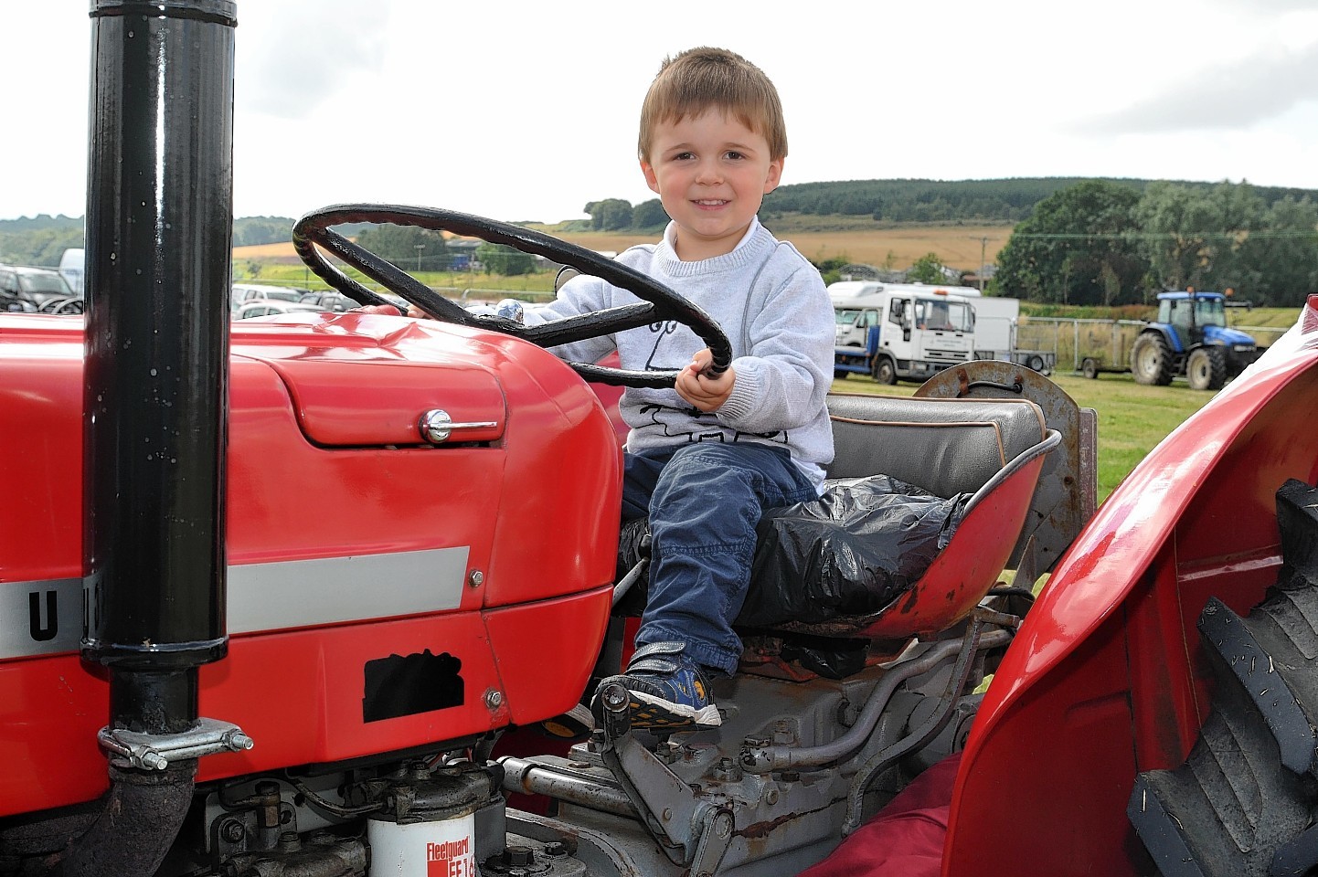 Lewis Donald (3), sitting on a tractor at the Turriff Show