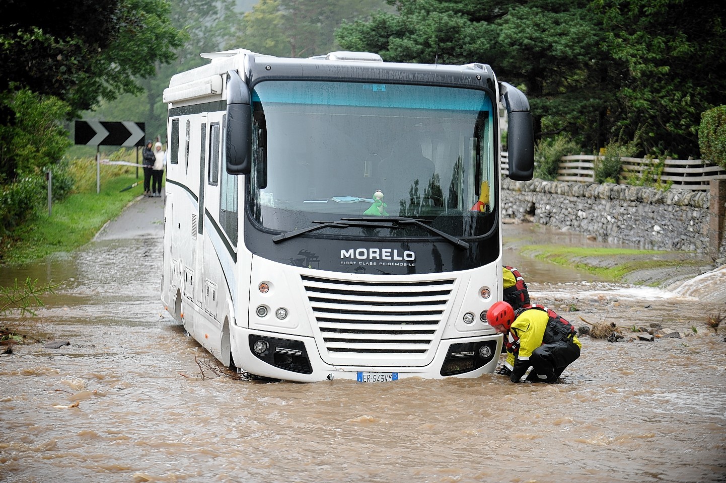 A bus battles through flooding near Ullapool