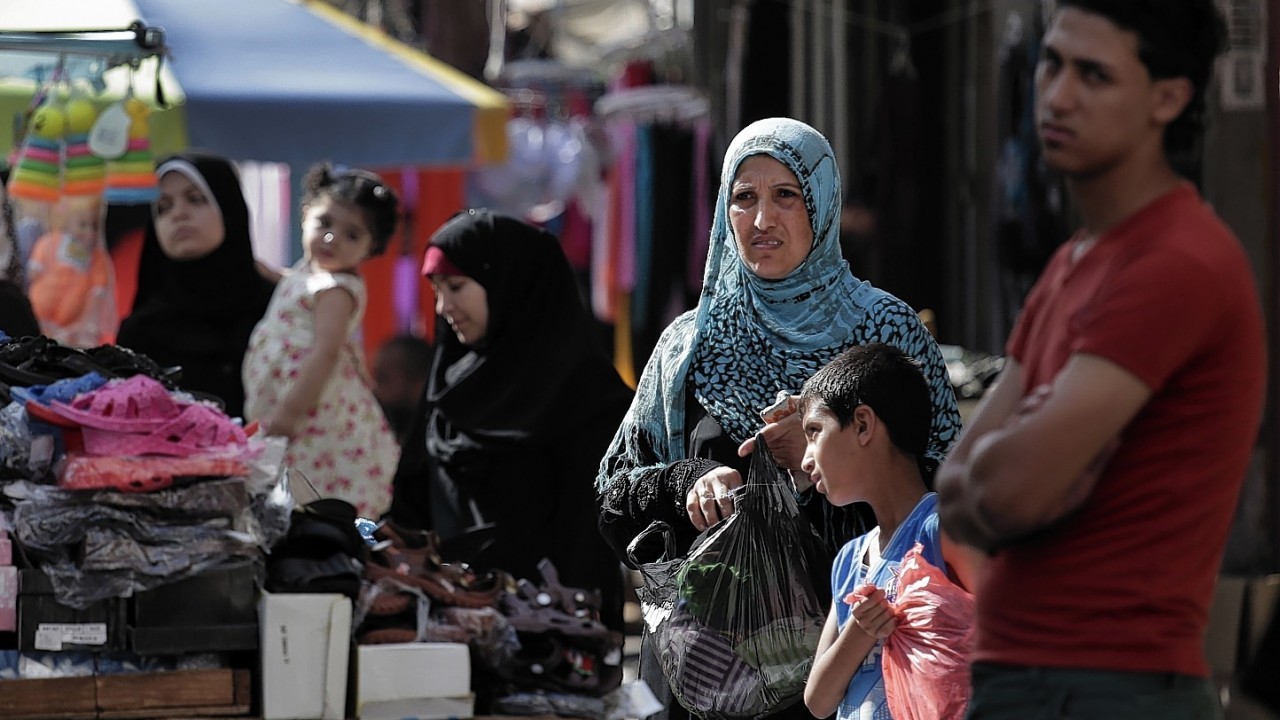 Palestinians shop at a market in Gaza City, northern Gaza Strip, Wednesday, Aug. 6, 2014.