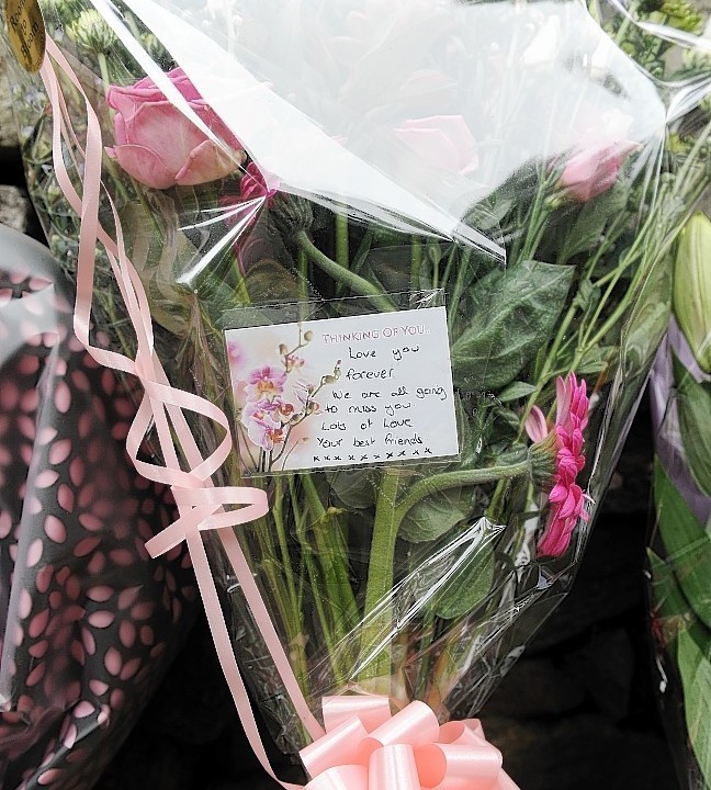 Floral tributes and messages of sympathy for Charlotte Hornby at the scene close to where her body was found on Sunday evening close to Island Bank Road, Inverness.