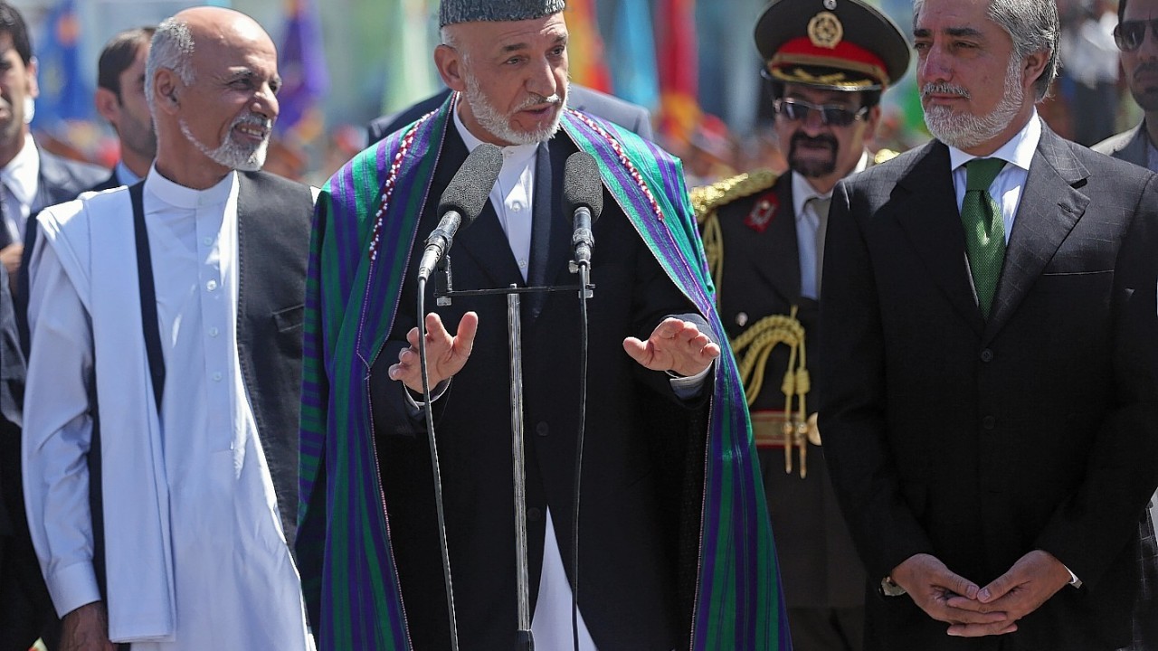 Afghan President Hamid Karzai, center, speaks in  front of local and international media representatives