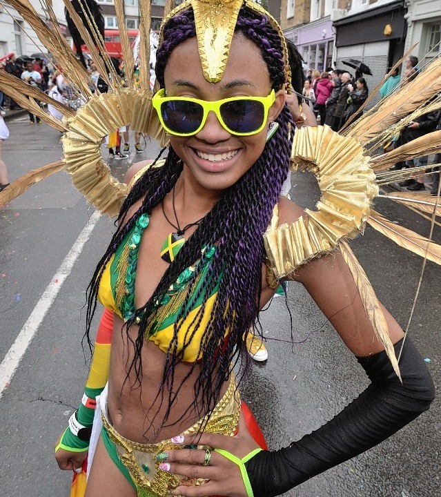 Participants take part in a rainswept Notting Hill Carnival in west London