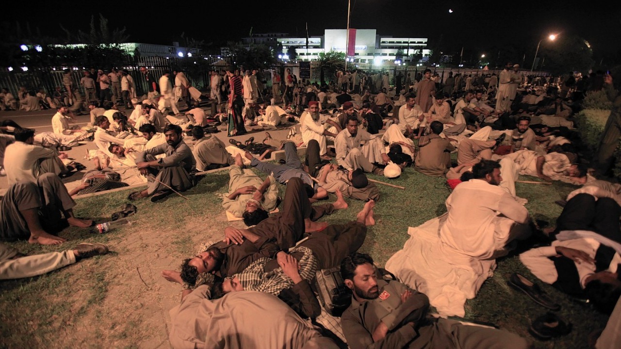 Supporters of Pakistani religious cleric Tahir-ul-Qadri rest in front of The Parliament building during a massive rally in Islamabad, Pakistan, Wednesday, Aug. 20, 2014.
