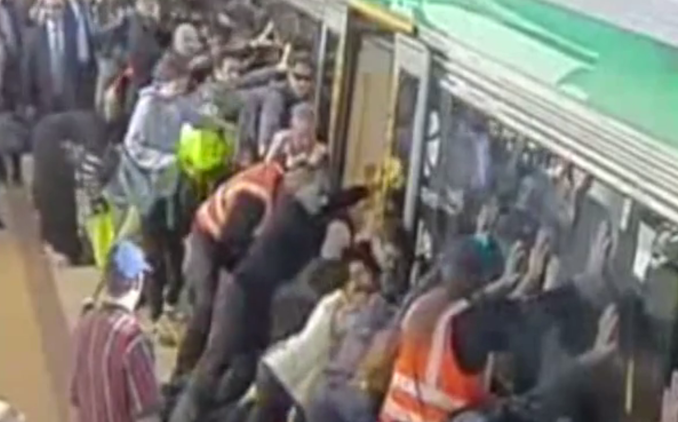 Passengers at rail station in Australia unite to rescue a man whose leg became trapped between the train and platform