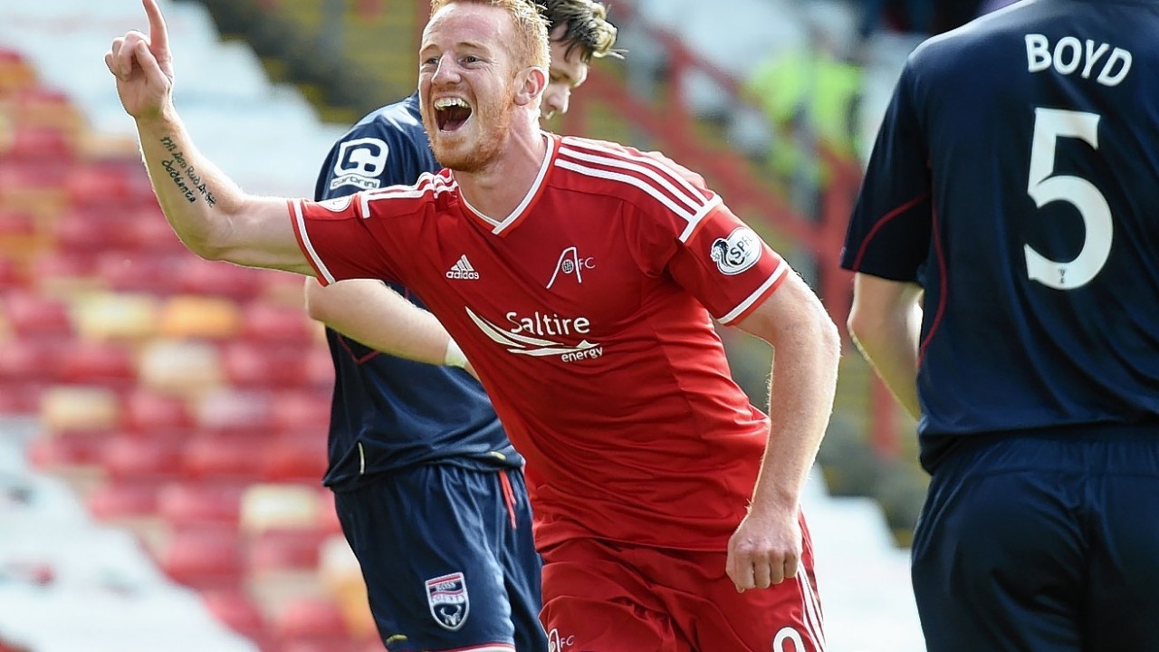 Rooney celebrates returning to the Dons starting 11 with a goal
