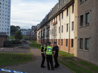 Police and forensics officers outside the flat on Balnagask Avenue, Aberdeen