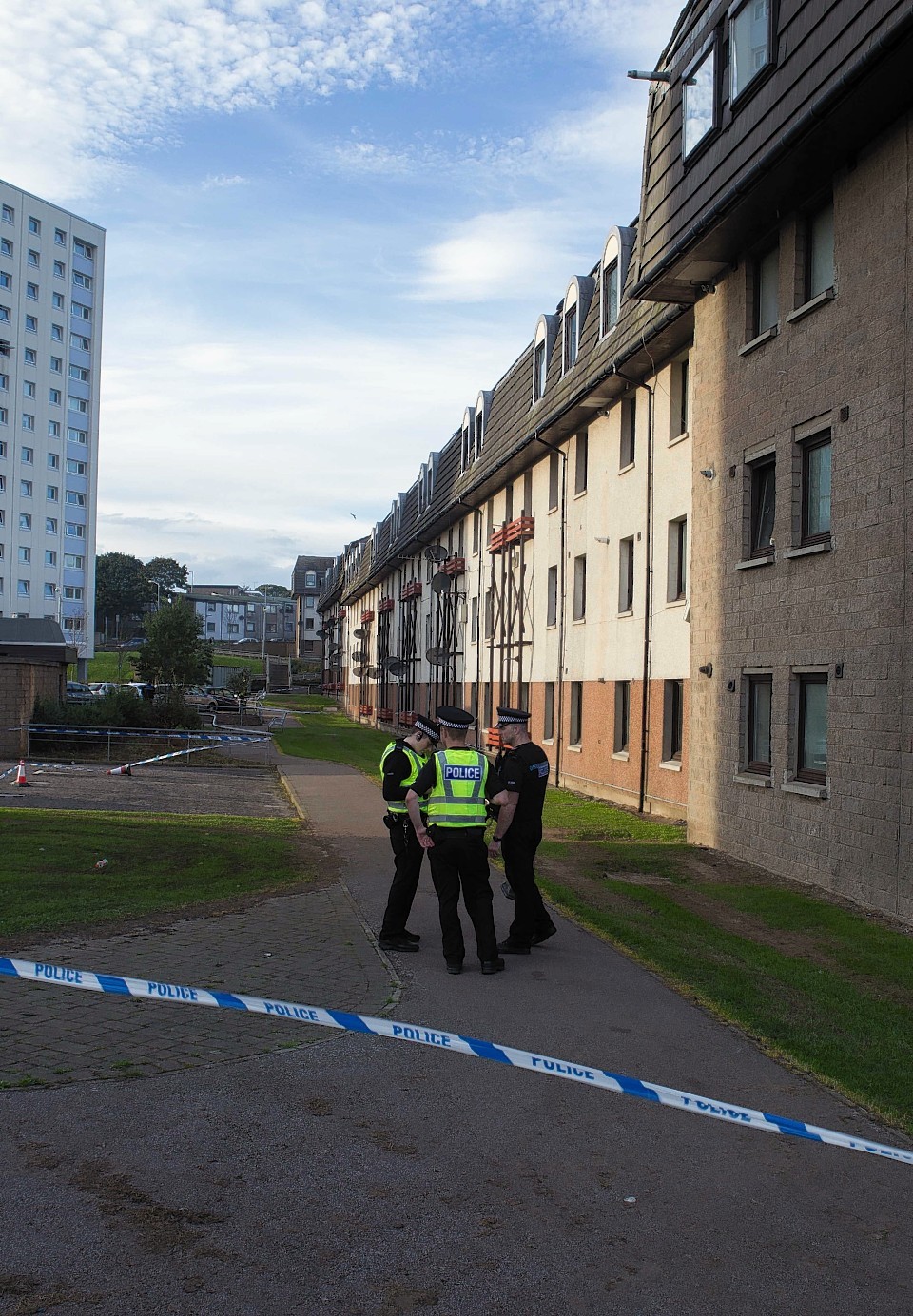 Police and forensics officers outside the flat on Balnagask Avenue, Aberdeen