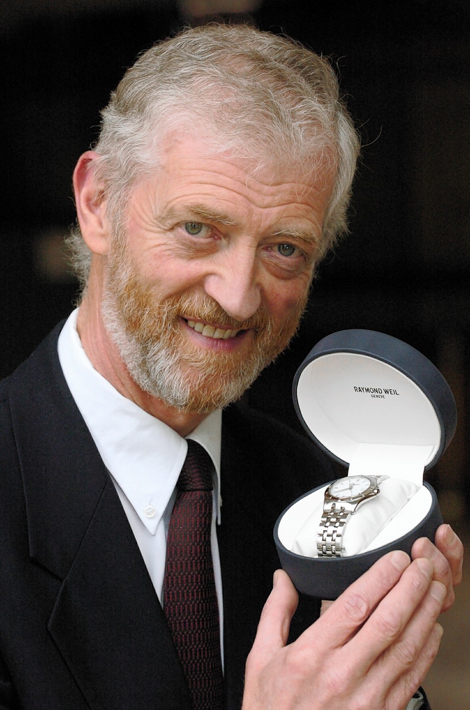 Bill Johnston on his retirement from Aberdeen Grammar School in 2004 with a watch which was a gift from the pupils