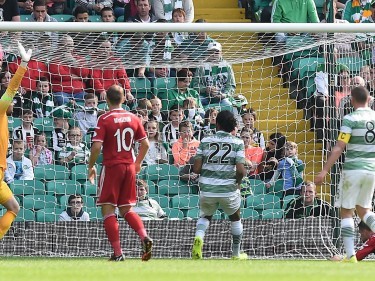 David Goodwillie stoops to pull a goal back for the Dons