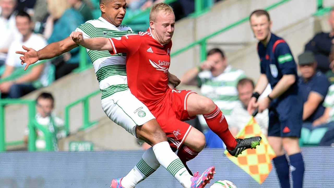 Emilio Izaguirre clatters Nicky Low when the two teams met earlier this season