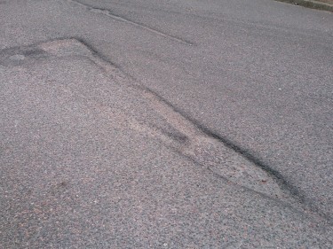 The pothole shaped like a Give Way symbol.