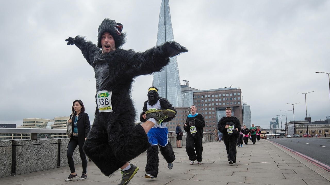 Runners cross London Bridge, with the Shard in the background, during The Great Gorilla Run in London today.