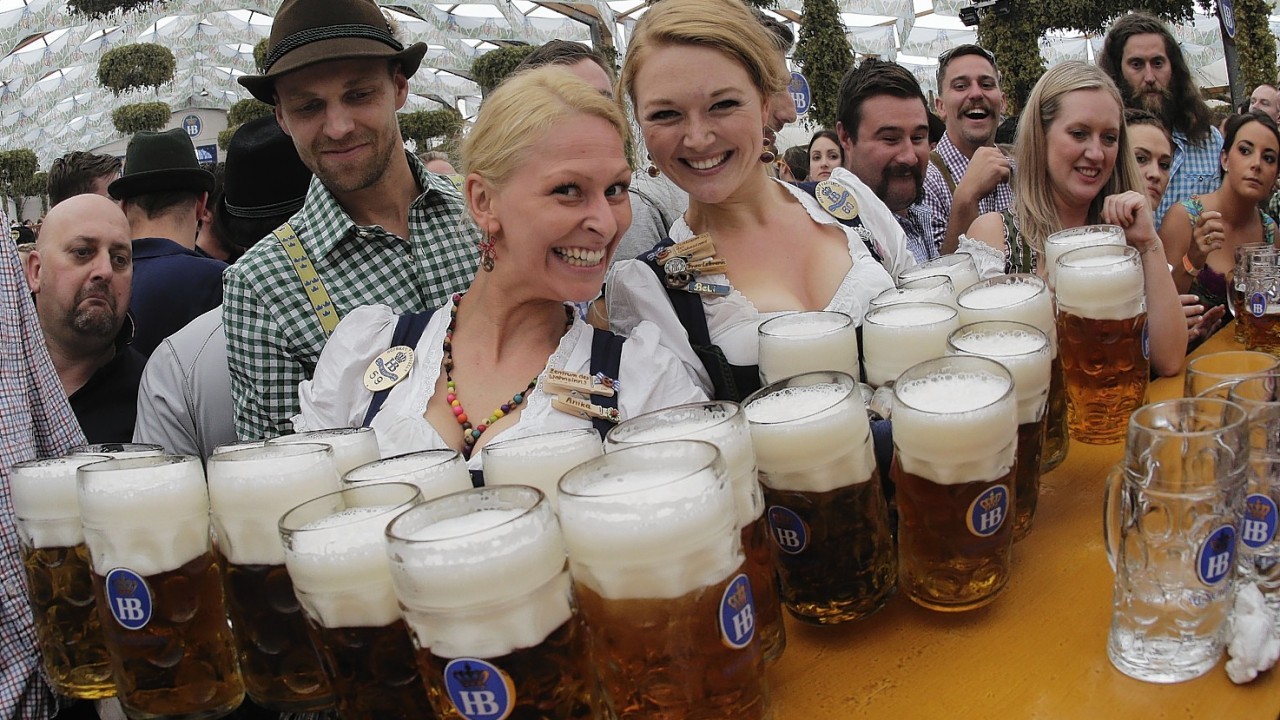Waitresses Beli, right, and Anika pose with beer mugs during the opening of the 181th Oktoberfest beer festival in Munich, southern Germany.